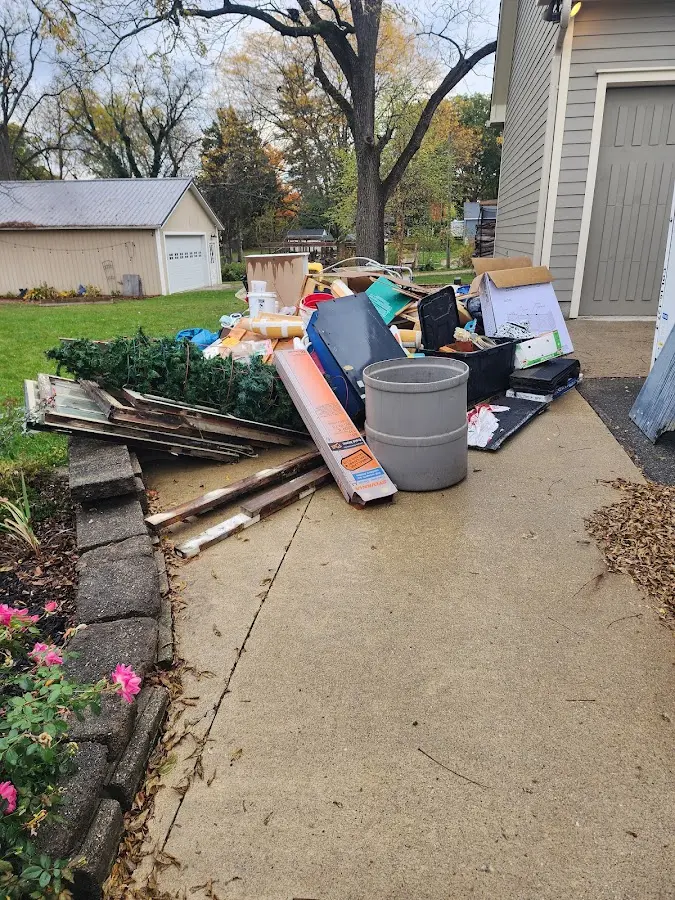 Dumpster being loaded with debris for Estate Cleanout Dumpster Rental in Franklinton